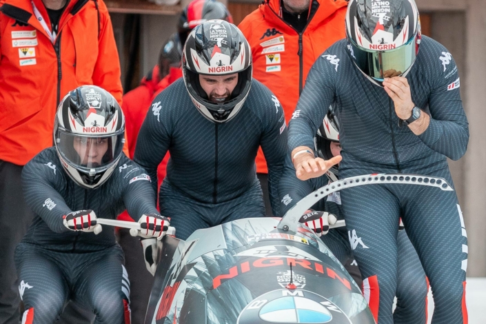 A group of bobsledders on a track.