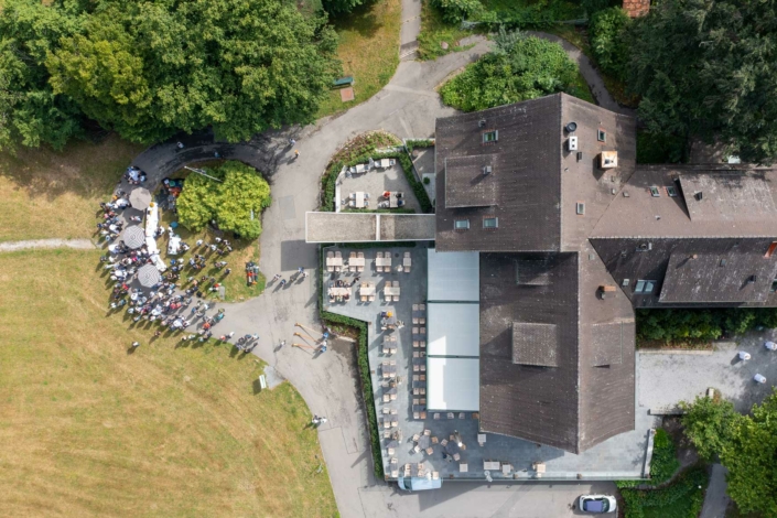 An aerial view of a large building with people gathered around it.